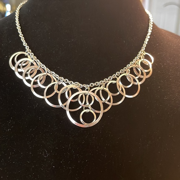 Light silver toned necklace with a variety of circles suspended on silver chain - Picture 5 of 13